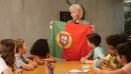 listening to teacher s story about Portugal, child examines this country on globe. High quality FullHD footage