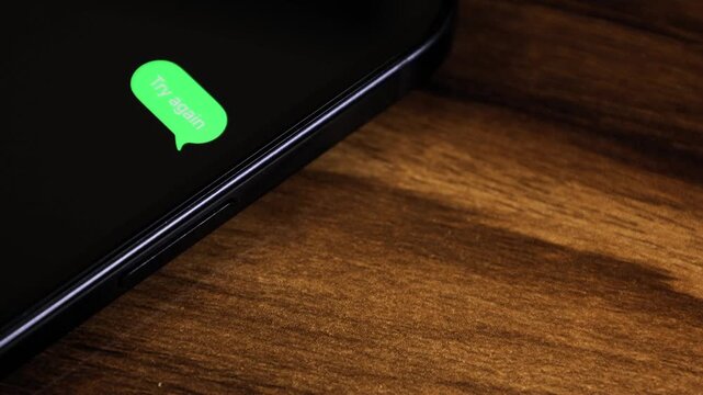Close-up view of a smartphone screen showing an outgoing &ldquo;Try Again&rdquo; text message in a green bubble, captured as it sends with a smooth popup animation.