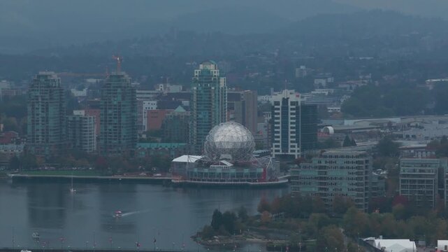 Telephoto panning aerial shot of Science World on a rainy afternoon in Vancouver, British Columbia, Canada. 4K