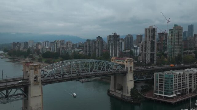 Low panning aerial shot of Burrard Bridge on a rainy day in Vancouver, British Columbia, Canada. 4K