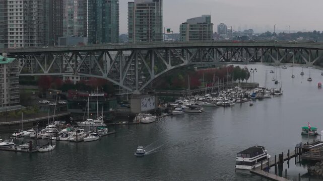 Telephoto aerial rising shot of Granville Bridge on a rainy day in Vancouver, British Columbia, Canada. 4K