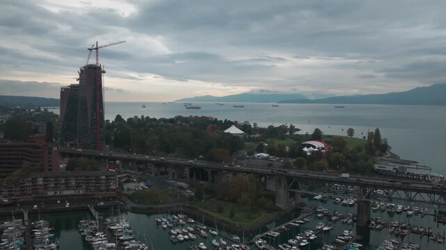 Wide panning aerial shot of Burrard Bridge at Vanier Park on a rainy morning in Vancouver, British Columbia, Canada. 4K