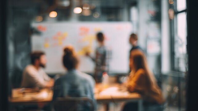 Blurred business team brainstorming session near a whiteboard wall. High quality