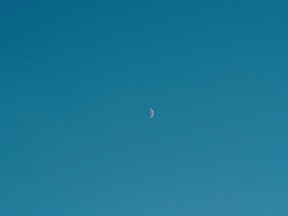 Minimal Blue Sky Background with Clean Gradient Atmosphere and Tiny Distant Bird in Calm Open Space
