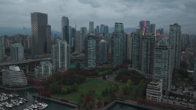 Aerial rising and panning shot of George Wainborn Park during rainy weather in downtown Vancouver, British Columbia, Canada. 4K