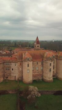 Aerial vertical shot around Pommiers en Forez priory on an overcast day in Loire departement, Auvergne RHone Alpes region, France