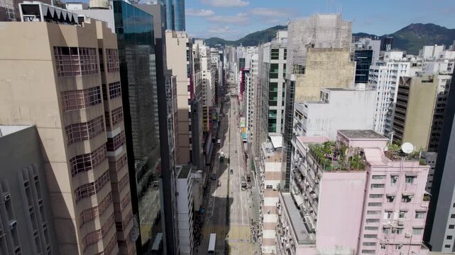 Hong Kong City fly-through Kowloon District between buildings up the Nathan road, aerial view of a densely populated Mong Kok area