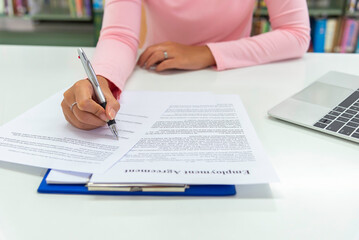 Close up view  woman sit at table hold take  notes to paper notebook working .businesswoman