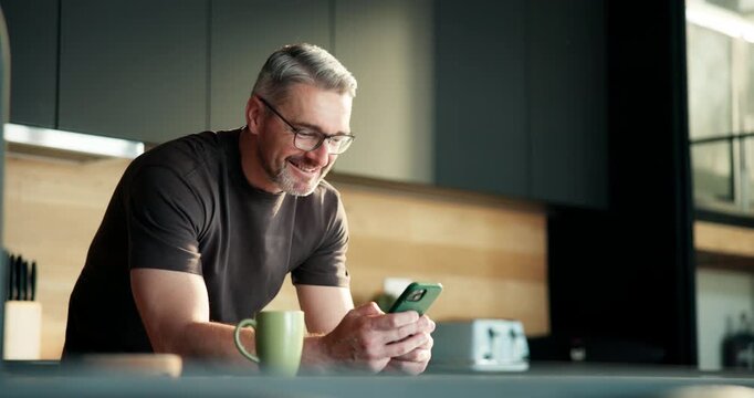 Phone, coffee and laughing with man in kitchen for online blog, reading and research. Social media, communication app and meme with mature person and tea in home for streaming, funny or contact