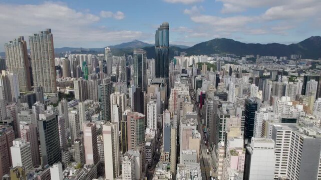 Hong Kong City, Kowloon District, aerial top view of a densely populated Mong Kok area and the famous Nathan road with a lot of residential and office buildings.