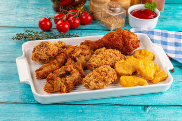 Golden crispy fried chicken mix - wings, drumsticks, nuggets and strips