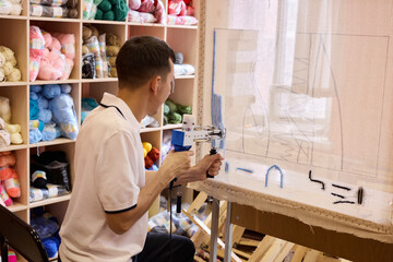 Crafting art with a tool in a colorful yarn shop