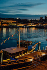 Fototapeta premium Traditional Rabelo boat docked on the Douro River at blue hour, Porto