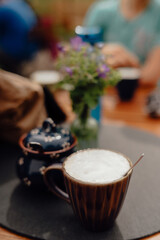 Cup of cappuccino and ceramic sugar pot at mountain café, Allgäu