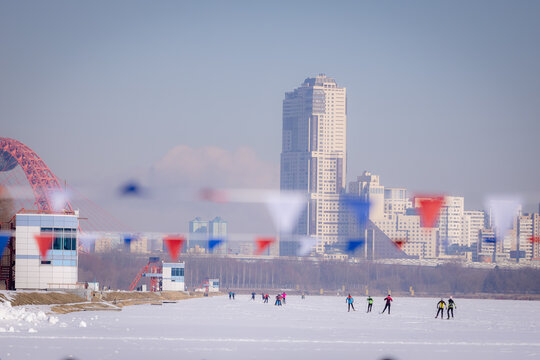 It's a sunny winter day and people are skiing.