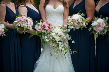 Bride and Bridesmaids with Elegant Bouquets in Navy Dresses