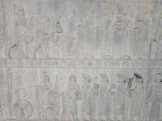 view of ancient stone carvings and weathered reliefs stand as silent witnesses to history at Persepolis, Marvdasht, Iran.