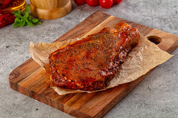 Raw marinated pork loin steak