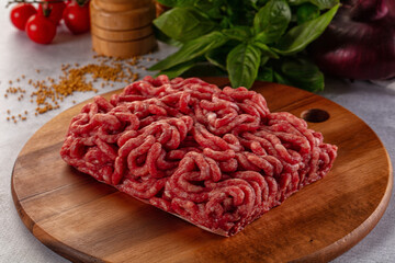 Raw minced beef meat over board