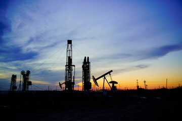 The oil pump, industrial equipment. Oil field site, oil pumps are running.