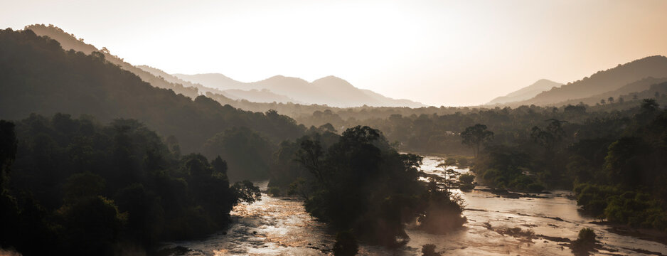  Majestic Athirappilly Falls Panorama in Kerala, India.  Panoramic view of the majestic Athirappilly Falls, often called 'The Niagara of India,' located in the  rainforests of Kerala's Western Ghats.