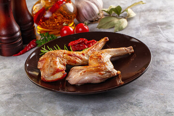 Roasted rabbit leg served rosemary