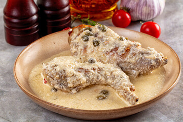 Roasted rabbit legs in cream sauce