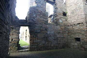 Eilean Donan Castle in Scotland, a historic medieval fortress perched on island, connected by a stone bridge and surrounded by scenic loch and hills.