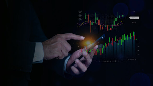 Businessman using smartphone to analyze digital candlestick charts, 
Stock market investment concept