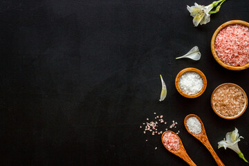 Spa treatment body care cosmetics - sea salt and scrubs in bowls, top view