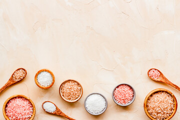 Spa composition with many different kinds of sea salt in bowls, top view