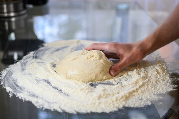 Making Fresh Yeast Dough by Hand with Flour on Kitchen Table, Close Up Process