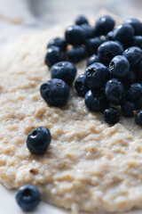 Oatmeal with juicy ripe blueberries for breakfast