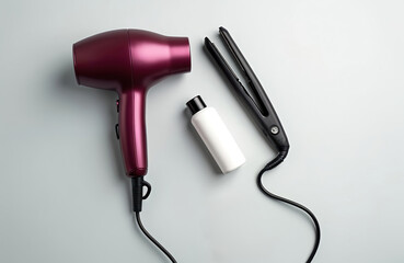 Fototapeta premium Hair dryer flat iron and bottle of product arranged on light grey background. Pro hair care tools for salon styling and home use. Modern beauty accessories for hair.