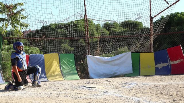 Young baseball batter hitting ball during game
