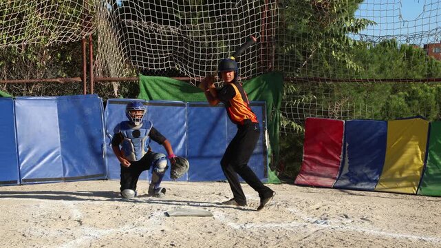 Baseball batter hitting ball and running to first base