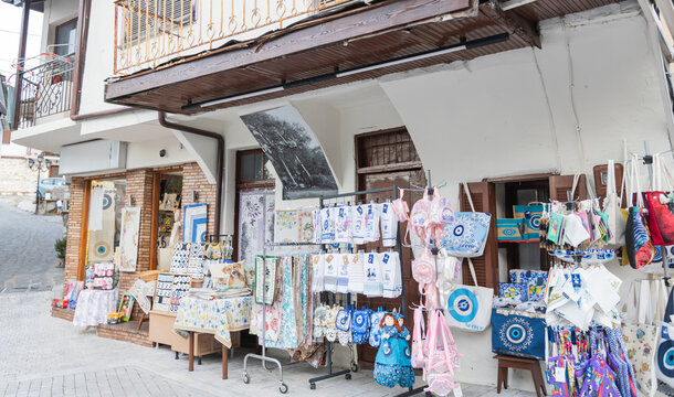 Traditional Greek souvenir shop with local textiles and handmade crafts in a village street