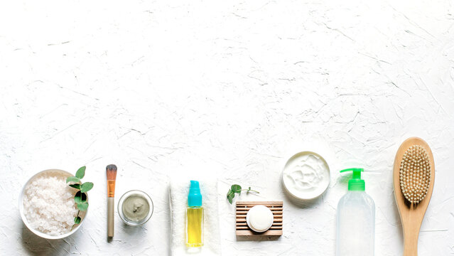 Spa essentials arranged on textured white surface, promoting relaxation, skincare, and wellness for a peaceful self-care routine
