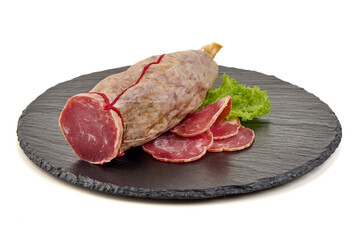 Saucisson sec sausage with lettuce on slate, isolated on white background