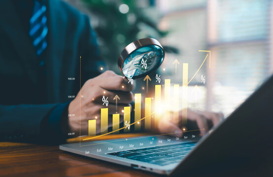 Business professional analyzing a rising financial chart with a magnifying glass, representing data analytics, market growth, investment performance, economic trends, and strategic decision-making - Powered by Adobe