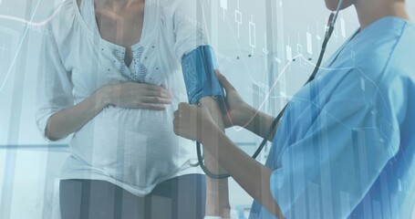 Checking pregnant patient cradling belly in clinic, nurse in scrubs fitting BP cuff and stethoscope