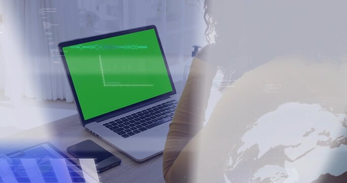 Typing woman in mustard top using laptop green screen at home, tablet, phone, overlays, copy space