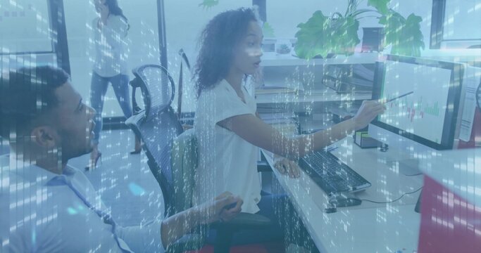 Pointing seated woman in white blouse explaining charts on open-plan office monitor, blue overlay - Powered by Adobe
