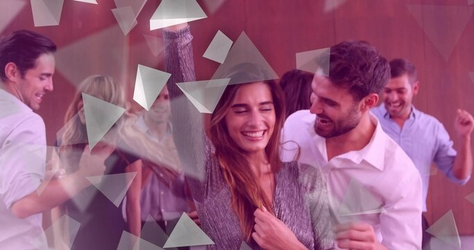 Dancing woman in wide-brim hat and grey knit top in wood-paneled room holding drink with confetti