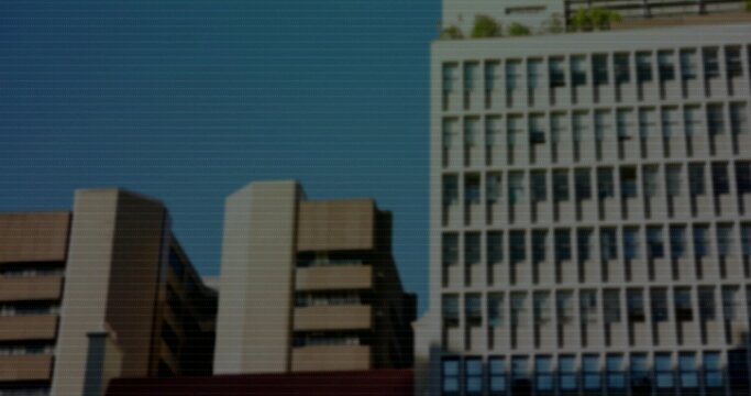 Showing midrise buildings lining left city street, with recessed windows and grid tower, copy space