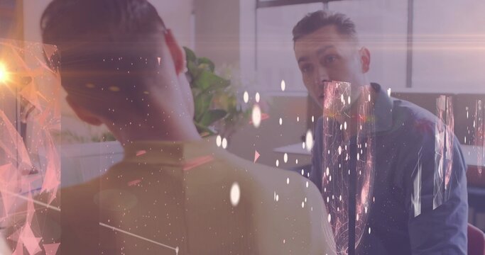 Talking collared man and high-collar woman maintaining eye contact in office, plant blinds overlays