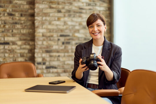 Professional Woman With Camera In Modern Office Conference Room Ready To Shoot Photos