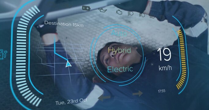 Inspecting female tech in navy coverall and gloves checking vehicle chassis at shop with Hybrid HUD - Powered by Adobe