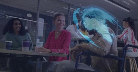Chatting office team holding takeaway cups around long table in lounge, showing wheelchair AR globe
