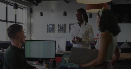 Speaking man in white shirt gesturing at team in open office, woman with headband, spreadsheet